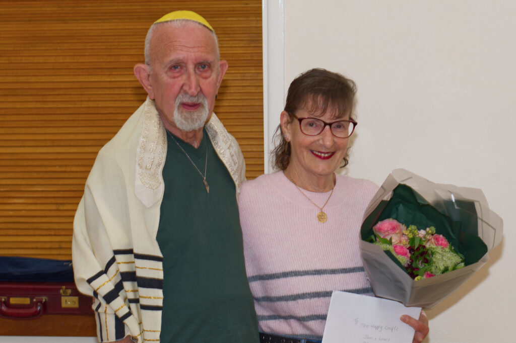 A couple celebrate their wedding anniversary with a community kiddish